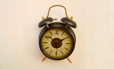 classic retro vintage aged black twin bell alarm clock with the hands pointing to 14 two 2 o'clock, isolated on clean white background symbolizing time deadlines Empty copy space for inscription © Maxim Chuev