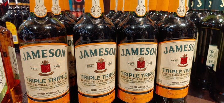 8 January 2026, Istanbul, Turkiye: Jameson Triple Irish Whiskey bottles with orange labels lined up on a retail store shelf, displaying the brand and product details