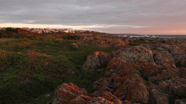 sunset light over rocky coastline of DeKelders, Gansbaai, South Africa