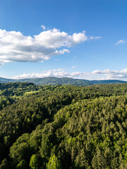 Fototapeta premium Drone view above forests, meadows and farmland in the Bavarian Forest countryside of Lower Bavaria