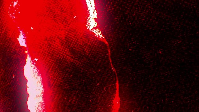 Fiery red texture with glowing highlights and dark background. A dramatic visual effect.
