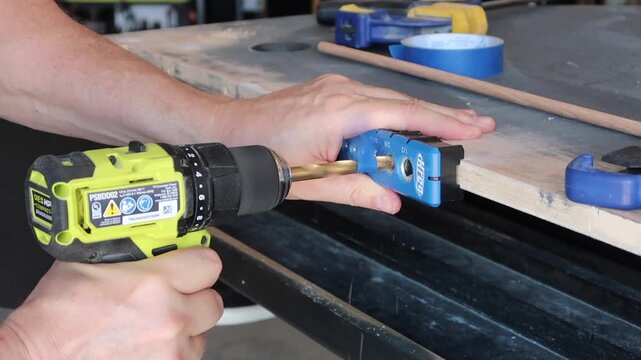 Drilling a 3/8 inch hole into a 3/4 inch piece of wood using a guide to keep it centered