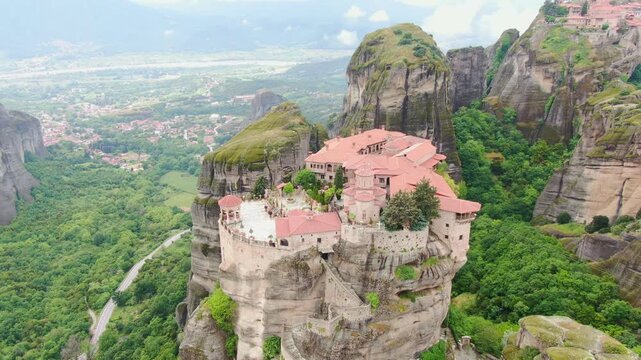 Aerial view of Meteora monasteries and the rock formations in the mountains of Greece  near Kalabaka city. Monastery of the Holy Trinity. Unesco world heritage site. Drone Video 