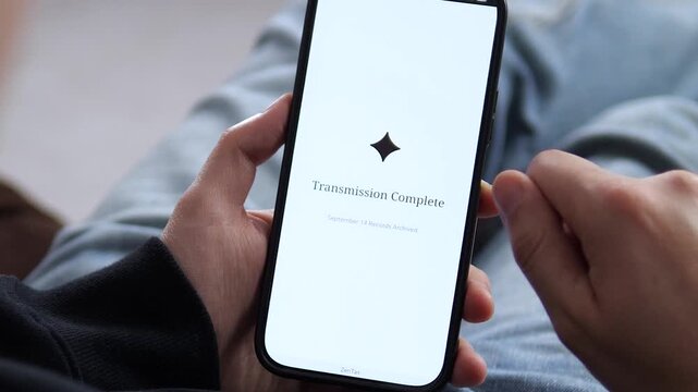 Hands holding a phone showing a clean, minimalist success screen. The message Transmission Complete signals the end of a tax process. Great for showcasing modern app design, zen aesthetics, and secure
