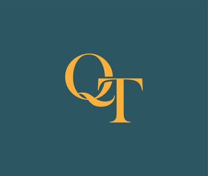 Golden letter QT logo on teal colored background  simple design