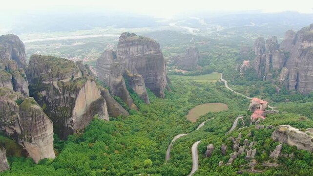 Aerial view of Meteora monasteries and the rock formations in the mountains of Greece  near Kalabaka city. Monastery of the Holy Trinity. Unesco world heritage site. Drone Video 