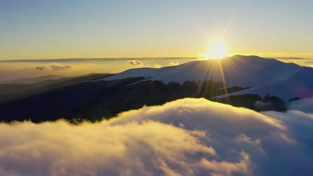 Bright sunlight shining over clouds from aerial perspective