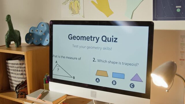 Close-up of computer screen on desk in kids bedroom, displaying questions from geometry quiz on online learning platform, illustrating digital homework, practice for exam, edtech, remote education