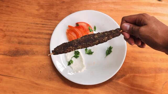Authentic Lebanese and Syrian kofta kebab skewer displayed in front of Brazilian flag, traditional Middle Eastern grilled meat street food concept with international cuisine and cultural fusion theme