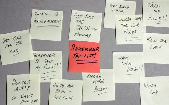 Sticky notes are placed on a wall with various reminders written on them. The notes include tasks for the day and important things to remember. Some notes are colorful, and one is larger.