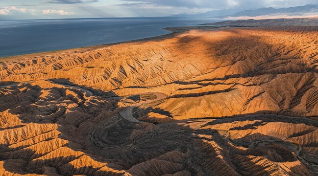 Evening mood, Canyon runs through landscape, Issyk Kul Lake, Dramatic barren landscape of eroded hills, Badlands, Canyon of the Forgotten Rivers, Issyk Kul, Kyrgyzstan