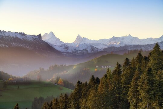 View of snow-covered Bernese Alps with Schreckhorn and Finsteraarhorn at sunrise, Langnau im Emmental, Canton of Bern, Switzerland
