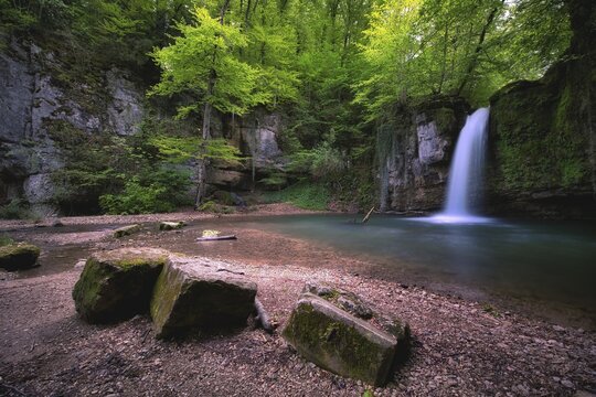 Waterfall in the forest with small pond near Kilchberg, Canton Basel-Landschaft, Switzerland