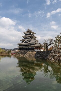 Old Japanese castle reflected in the moat, Matsumoto Castle, Matsumoto, Nagano, Japan