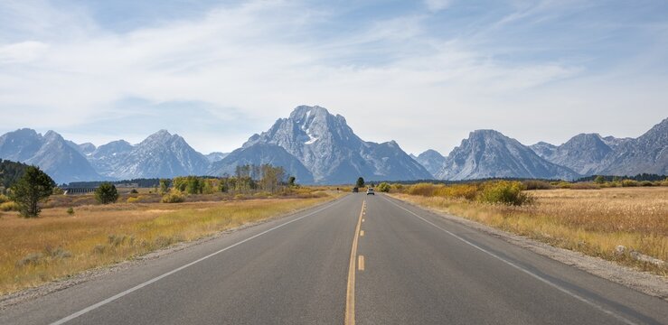 Country road in front of Grand Teton Range mountain, summit of Mount Moran, Grand Teton National Park, Wyoming, USA