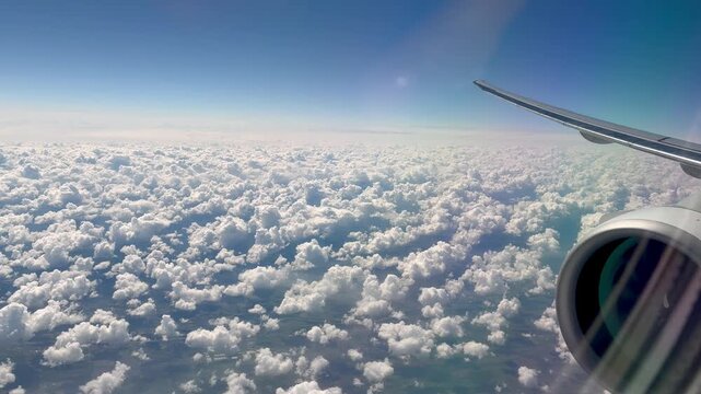 Engine and the airplane wing view fron the window over the cloudy sky