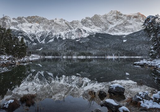 Lake Eibsee lake in winter with snow-covered Zugspitze at sunset, reflection, Wetterstein range, Upper Bavaria, Bavaria, Germany