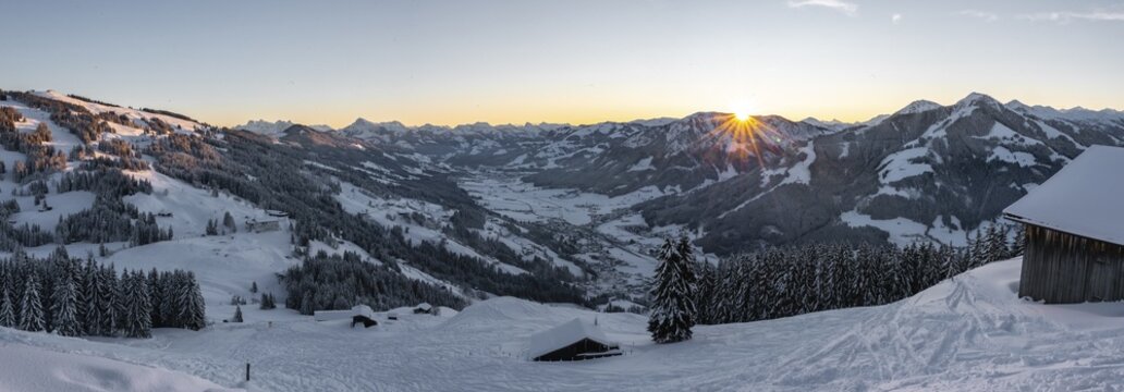 Panorama, view of the Brixen Valley with the first rays of sunshine, sunrise behind a mountain range in winter, Hochbrixen, Brixen im Thale, Tyrol, Austria