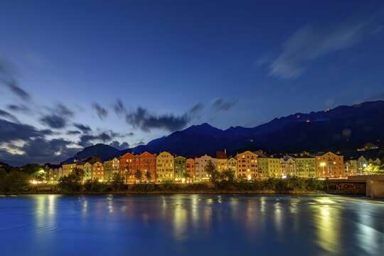 City view Innsbruck with Inn river in the foreground at blue hour, Innsbruck, Tyrol, Austria