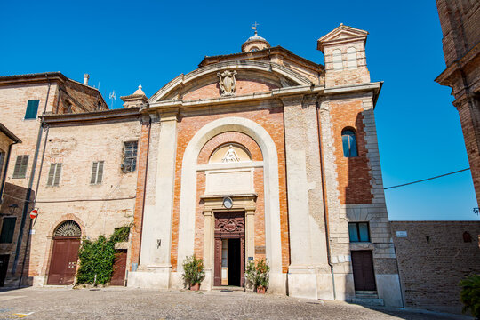 Sanctuary of Santa Maria Goretti in Corinaldo, Ancona province, showcasing its historic Baroque architecture with a prominent brick facade and an ornate entrance in the Italian sunlight