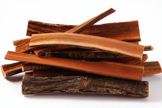 Pile of Catuaba bark pieces on white background. Natural wood with rough texture. Used for herbal remedies and traditional medicine in Brazil.