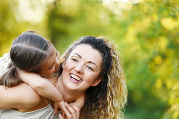 Fototapeta premium Mother with her cute little daughter in nature, closeup. Space for text