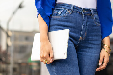 Woman holding a tablet outdoors, symbolizing contemporary communication, working digitally, and urban connectivity © Algamez