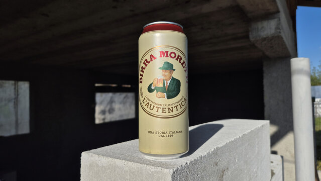 Birra Moretti L'Autentica beer can sitting on a concrete block at a construction site under bright, direct sunlight. Picture taken on May 1, 2026 in Ploiesti, Romania.