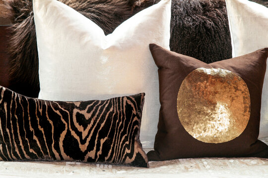 Cream and brown neutral pillows with animal print and metallic accent
