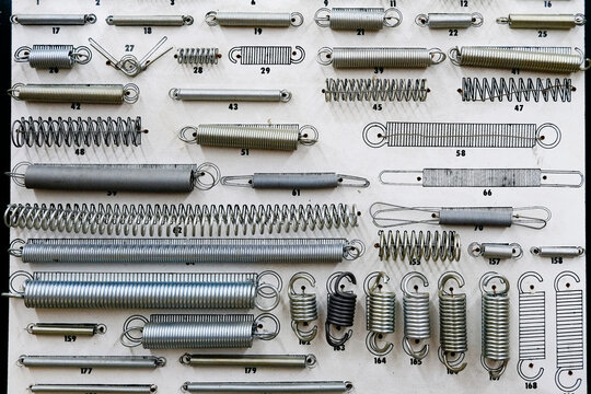 Display of metal springs and hardware on a workshop board