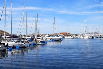 Fototapeta premium The harbor is home to modern watercraft, summer recreational vessels, yachts, and recreational and fishing boats.