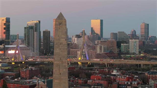 Bunker Hill Monument with Boston skyline and Zakim Bridge at dawn