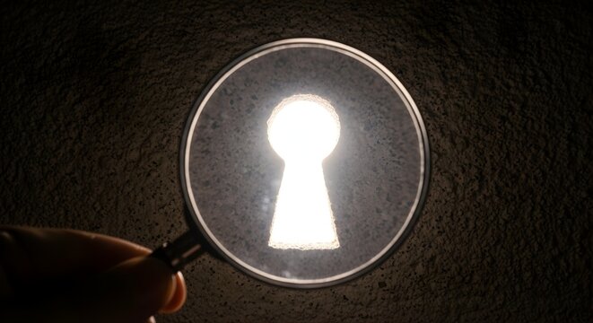 Magnifying glass focused on bright glowing keyhole shape in dark stone wall representing mystery discovery security access solution and searching for hidden truth or secret passage opportunity