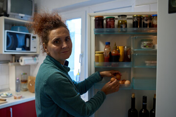 Woman taking eggs from fridge © Xalanx