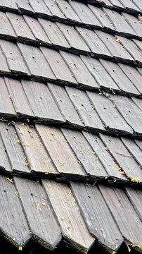 Authentic wooden roof of traditional Central European architecture, weathered timber shingles.