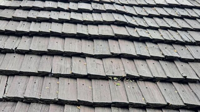 Authentic wooden roof of traditional Central European architecture, weathered timber shingles.