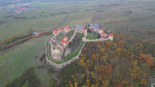 High angle view of the restored Rupea medieval citadel built on a basalt rock in Brasov, Transylvania. Spectacular historic Saxon fortress in a scenic Romanian rural landscape.