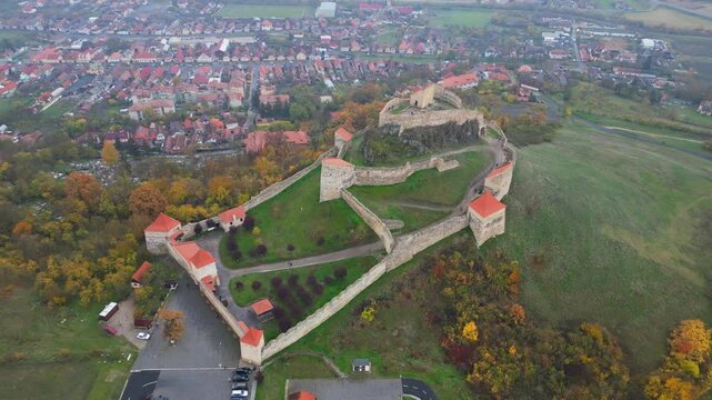High angle view of the restored Rupea medieval citadel built on a basalt rock in Brasov, Transylvania. Spectacular historic Saxon fortress in a scenic Romanian rural landscape.