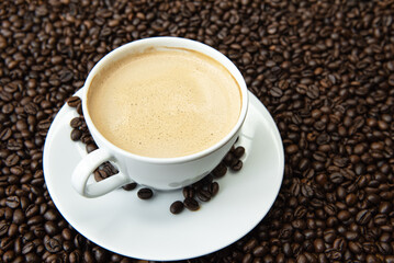 Fototapeta premium Premium dark roast arabica coffee beans with cozy cup of warm steaming and delicious coffee 