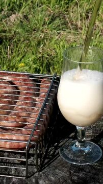 Grilled sausages and steaks Snacks with meat, sausage, French fries, crackling and beer. High quality 4k footage