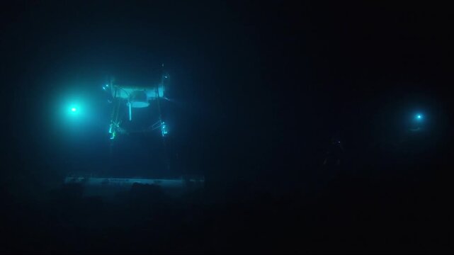 Underwater robotic vehicle with bright lights exploring the dark depths of the ocean