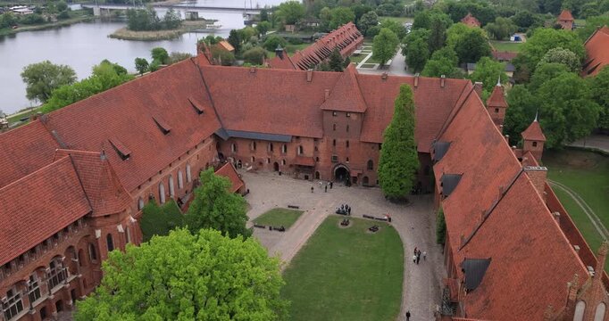 Poland Malbork Castle brick coutyard river. Medieval castle of the Teutonic Order. 13th century, Largest castle in the world by land area, 52 acres. Historical buildings. Educational displays.