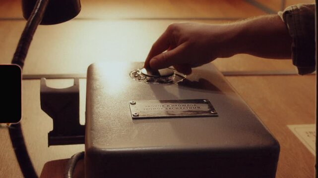 Person using a vintage rotary dial telephone