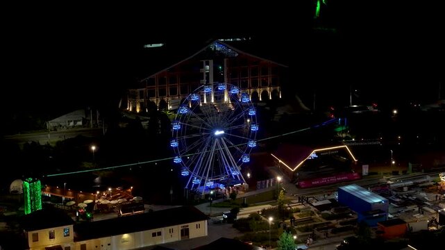 Night View Of Capivari Village In Campos Do Jordao In Sao Paulo Brazil. Illuminated Ferris Wheel. Downtown Cityscape. European Architecture. Capivari Village In Campos Do Jordao In Sao Paulo Brazil. 