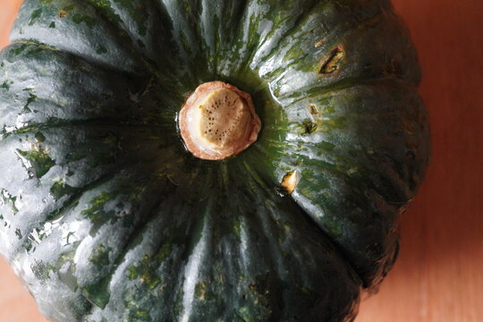Close-up Top View of Fresh Kabocha Squash on Wooden Surface