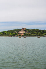 Fototapeta premium Scenic Lake View with Traditional Pavilion on Wooded Hill