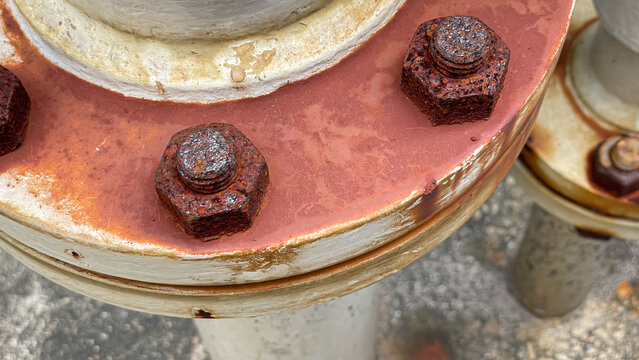 Close up of stud bolt and nut connect two pipe flanges in an industrial plant, symbolizing engineering design, strength,