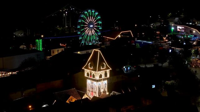 Night View Of Capivari Village In Campos Do Jordao In Sao Paulo Brazil. Illuminated Ferris Wheel. Downtown Cityscape. European Architecture. Capivari Village In Campos Do Jordao In Sao Paulo Brazil. 