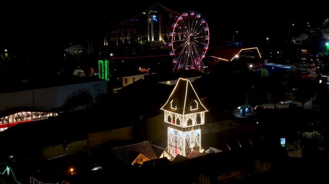 Night View Of Capivari Village In Campos Do Jordao In Sao Paulo Brazil. Illuminated Ferris Wheel. Downtown Cityscape. European Architecture. Capivari Village In Campos Do Jordao In Sao Paulo Brazil. 