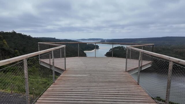 Furna do sapo viewpoint overlooking a winding river estuary surrounded by green forests under an overcast sky